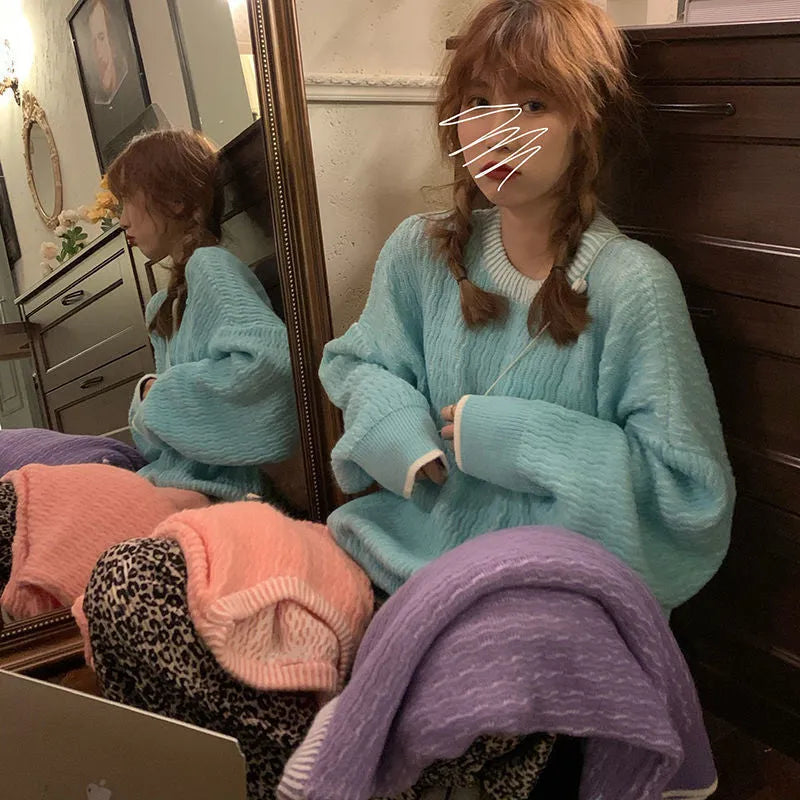Women's loose pullover sweater in lake blue, made from 100% polyester, showing regular sleeves and solid colour design.