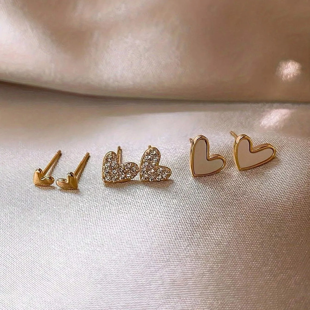 Three pairs of heart-shaped alloy earrings with electroplating in gold, black, black-white, and pink colours