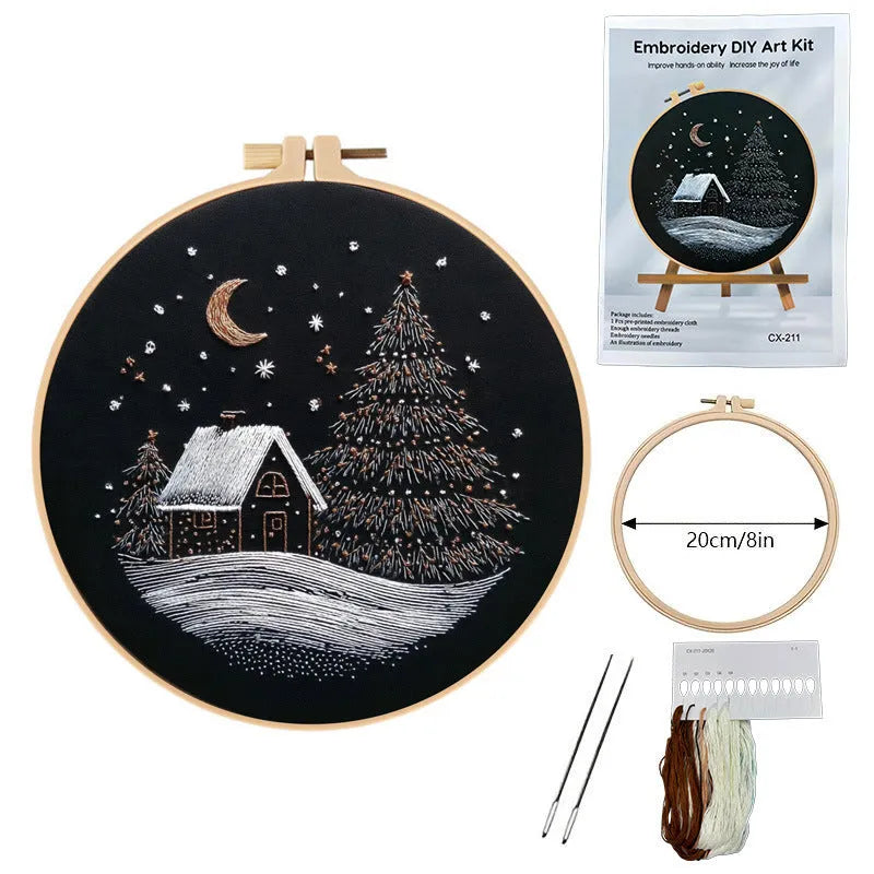 Christmas snow house embroidery kit showing 28cm square cotton linen fabric with printed landscape pattern.