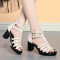 Women's beige hollow-out high heel sandals with rhinestones and a buckle fastening.