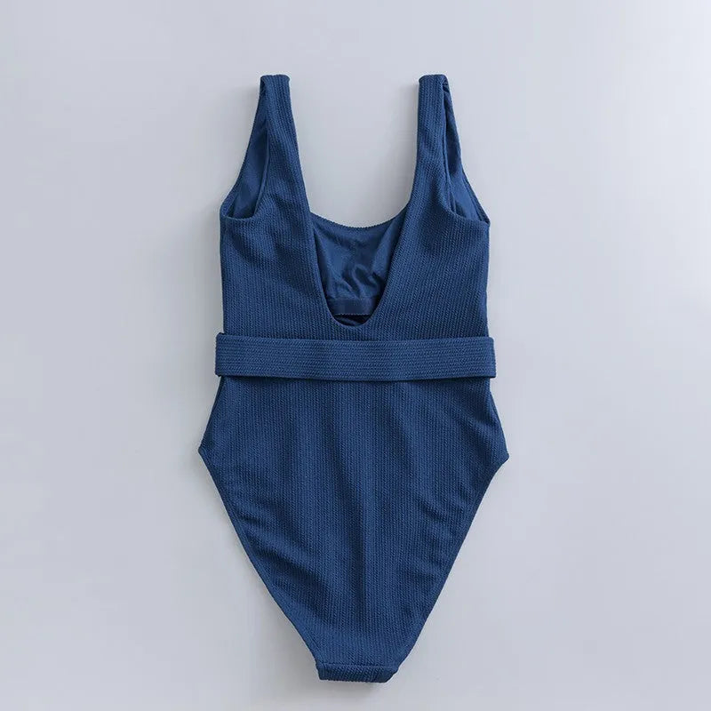 Women's navy blue one-piece swimsuit with triangle neckline and built-in chest padding
