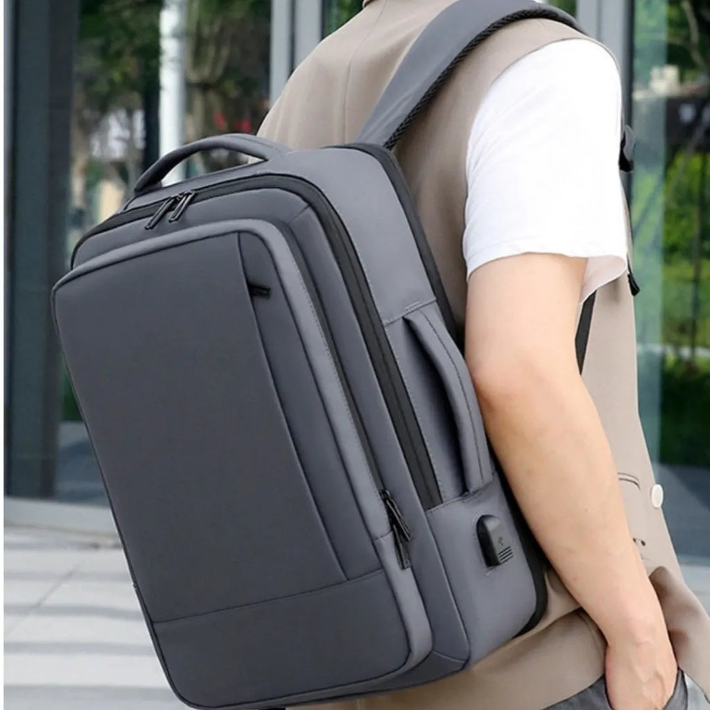 Black waterproof business backpack with 20-35L capacity and curved shoulder strap for commuting