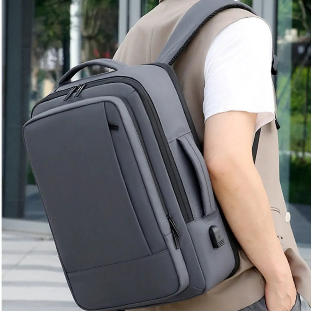 Black waterproof business backpack with 20-35L capacity and curved shoulder strap for commuting
