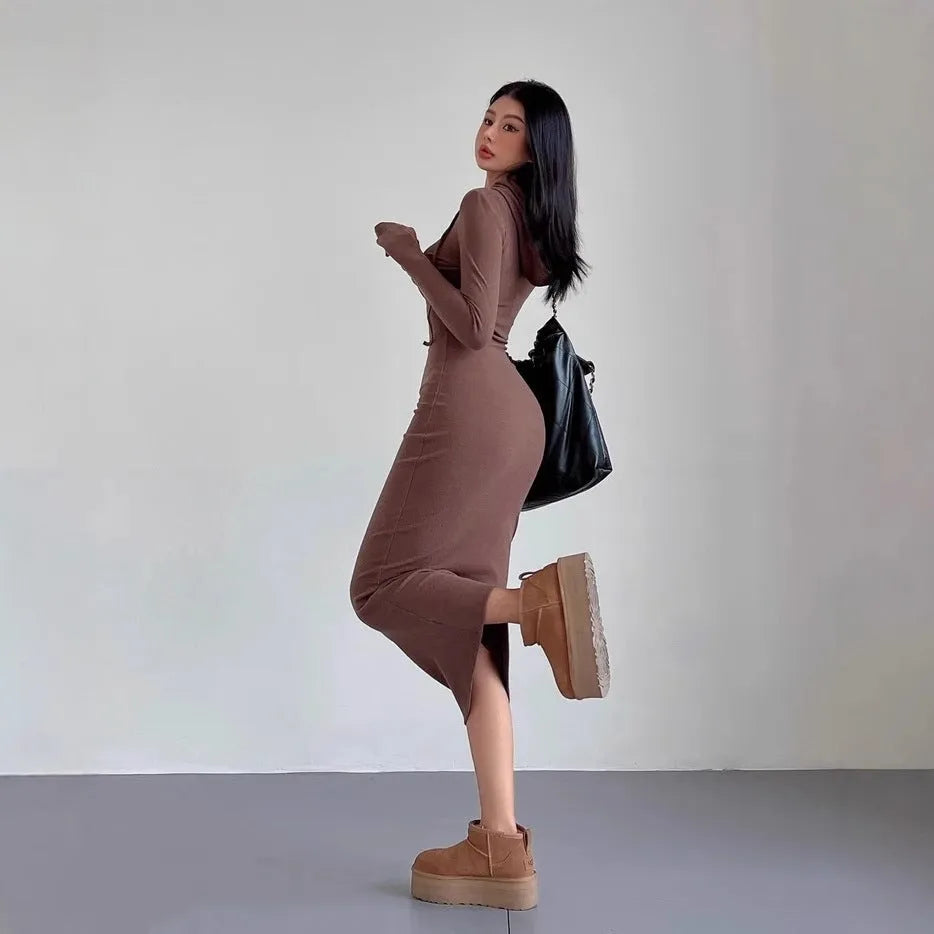 Women's grey hooded sheath dress with over-the-knee length and long sleeves showing high waist design