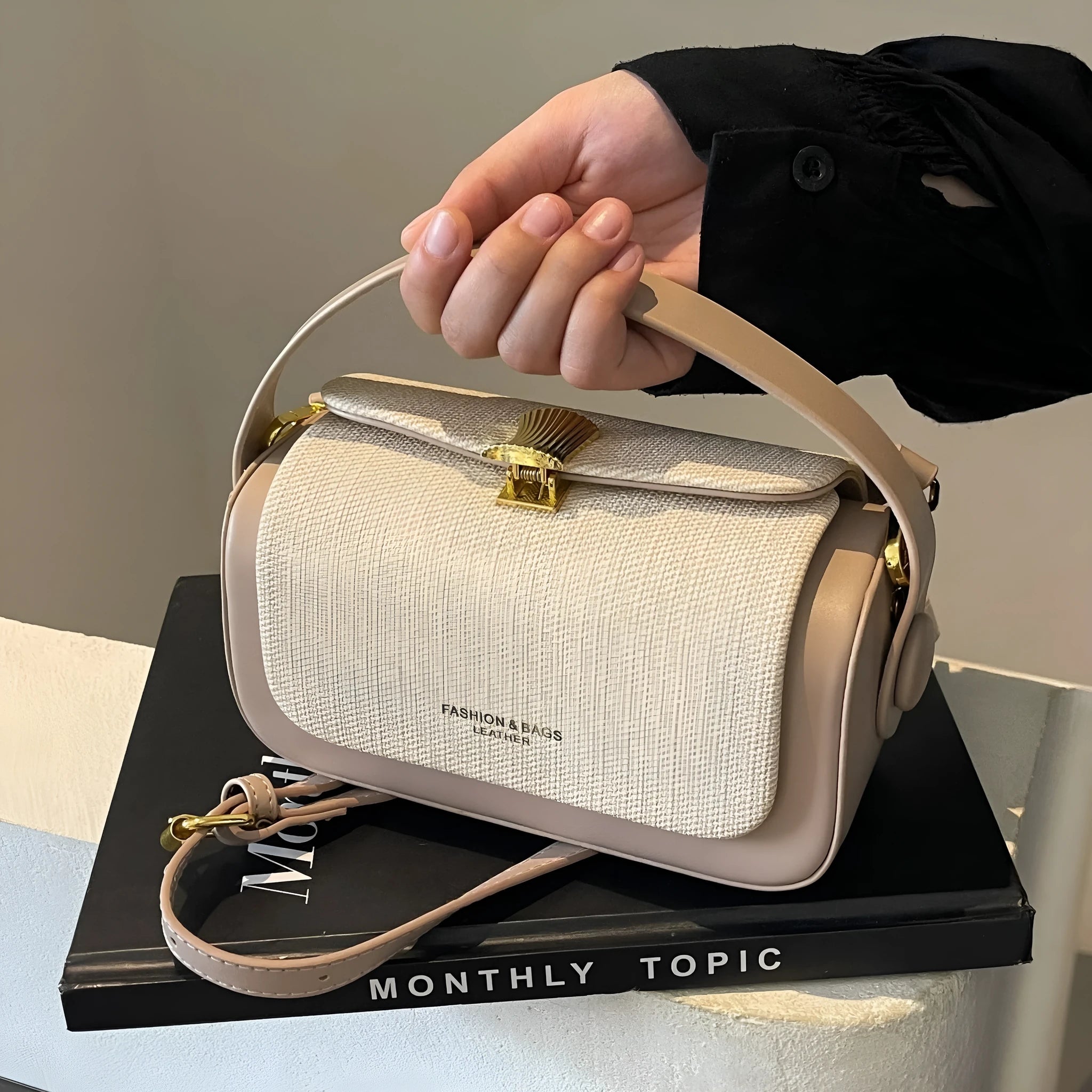Women's PU leather messenger bag in horizontal square shape with contrast stitching and lock fastening