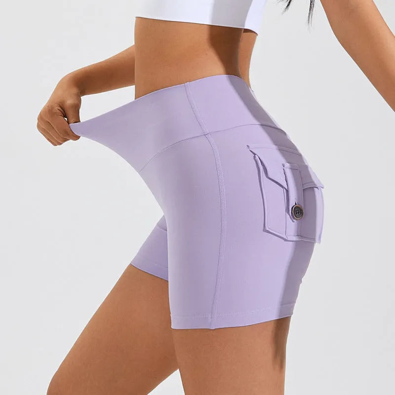 Women's high waist hip lifting shorts in avocado green with side pockets during yoga pose