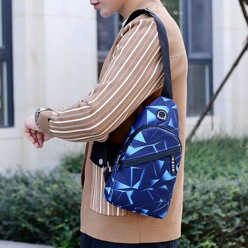 Men's crossbody chest sling bag in blue with earphone hole, zipper pockets, and soft handle, measuring 17x30x5cm