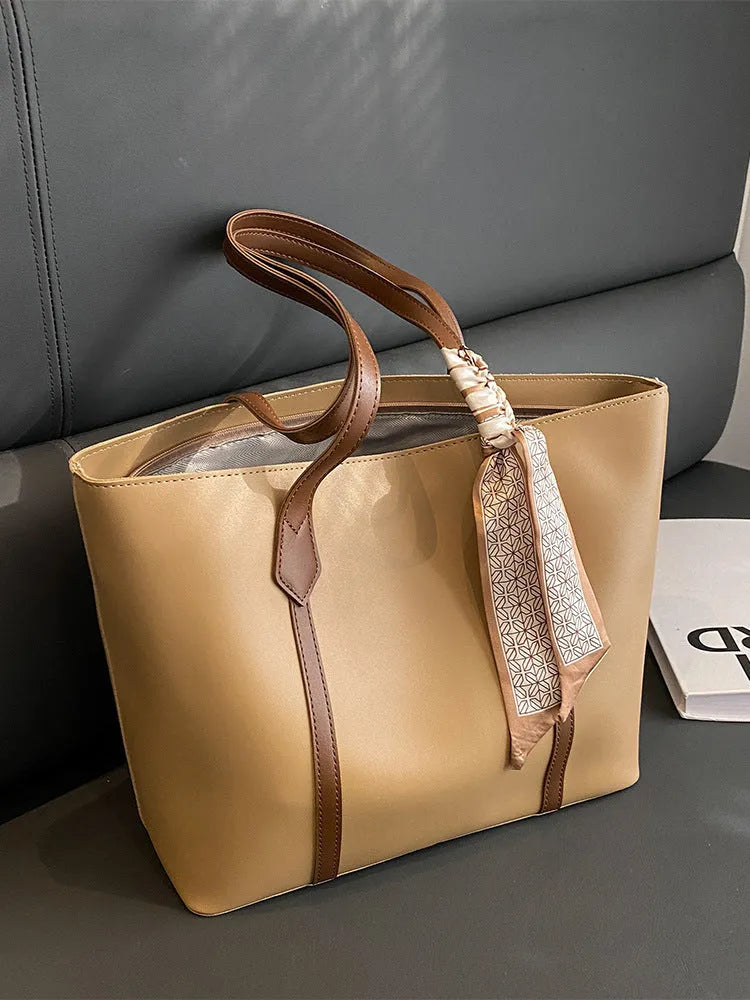 Soft tote bag with crossbody strap showing internal zipper compartment and khaki colour option