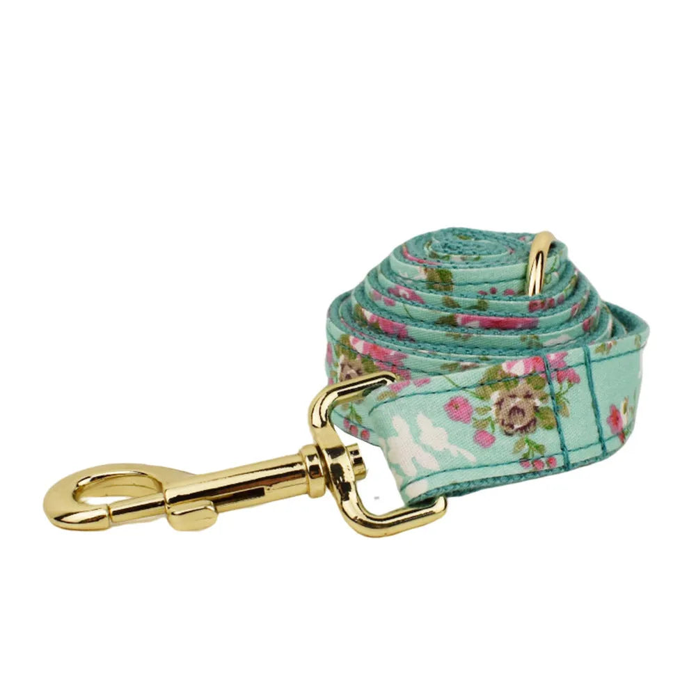 Rose pattern with green background fabric dog collar, leash, detachable bow, and vest set for pets.