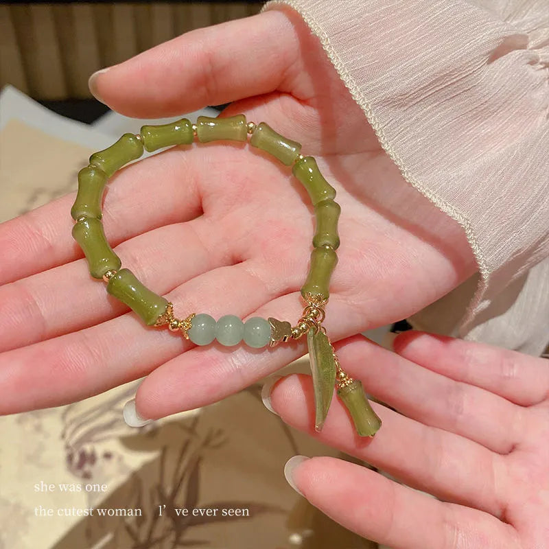 Chinese style bamboo leaf bracelet for women in glass with bamboo joint elements, showing manual processing and colour variations