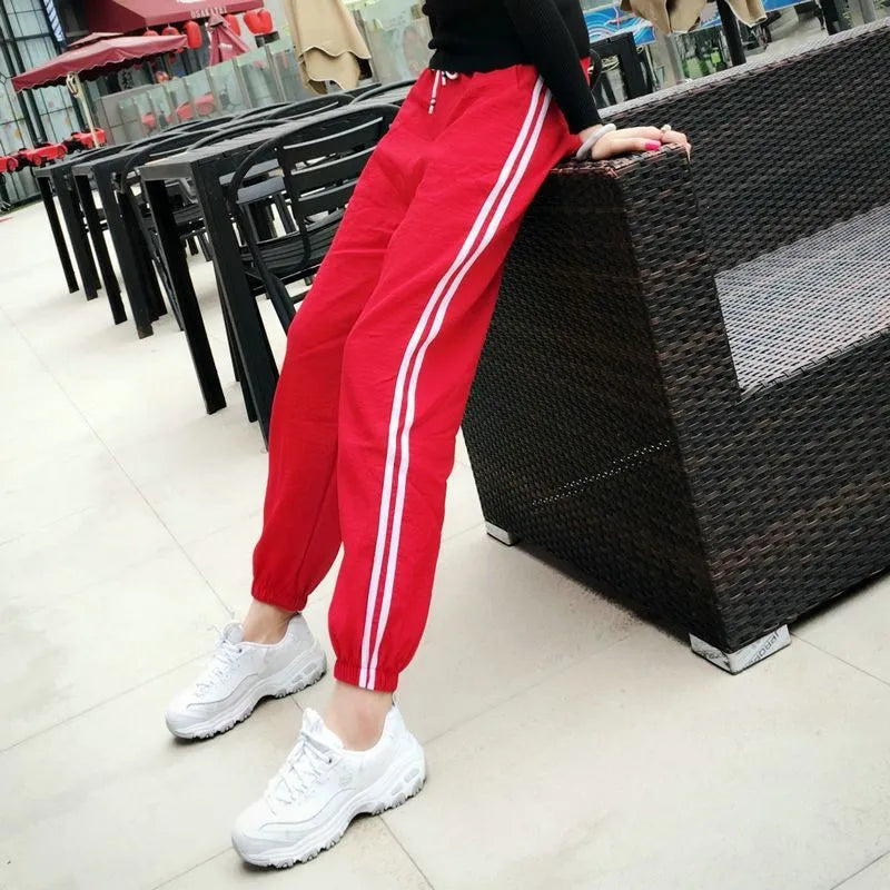 Women's cropped harem track pants in thin polyester, mid waist, solid colour, sizes S to 3XL