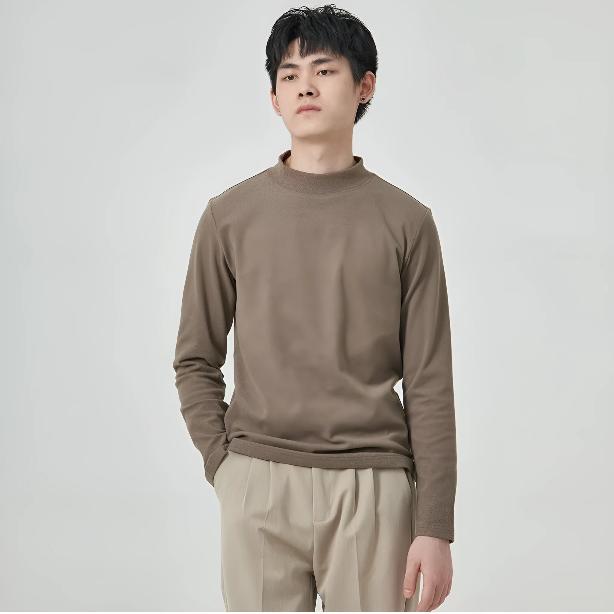 Man's brown long sleeve Dralon T-shirt with a half-high collar, laid flat.