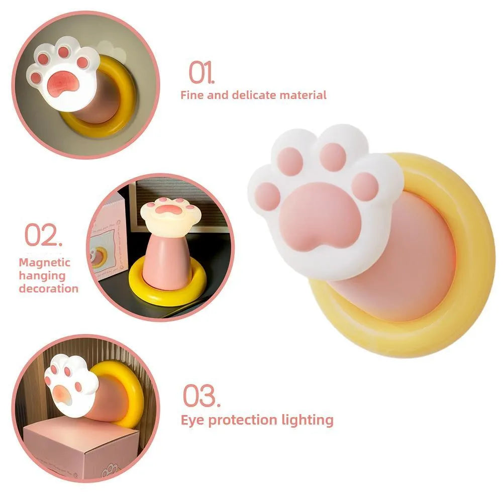 White cat paw shaped touch control night light lamp on a wooden nightstand.