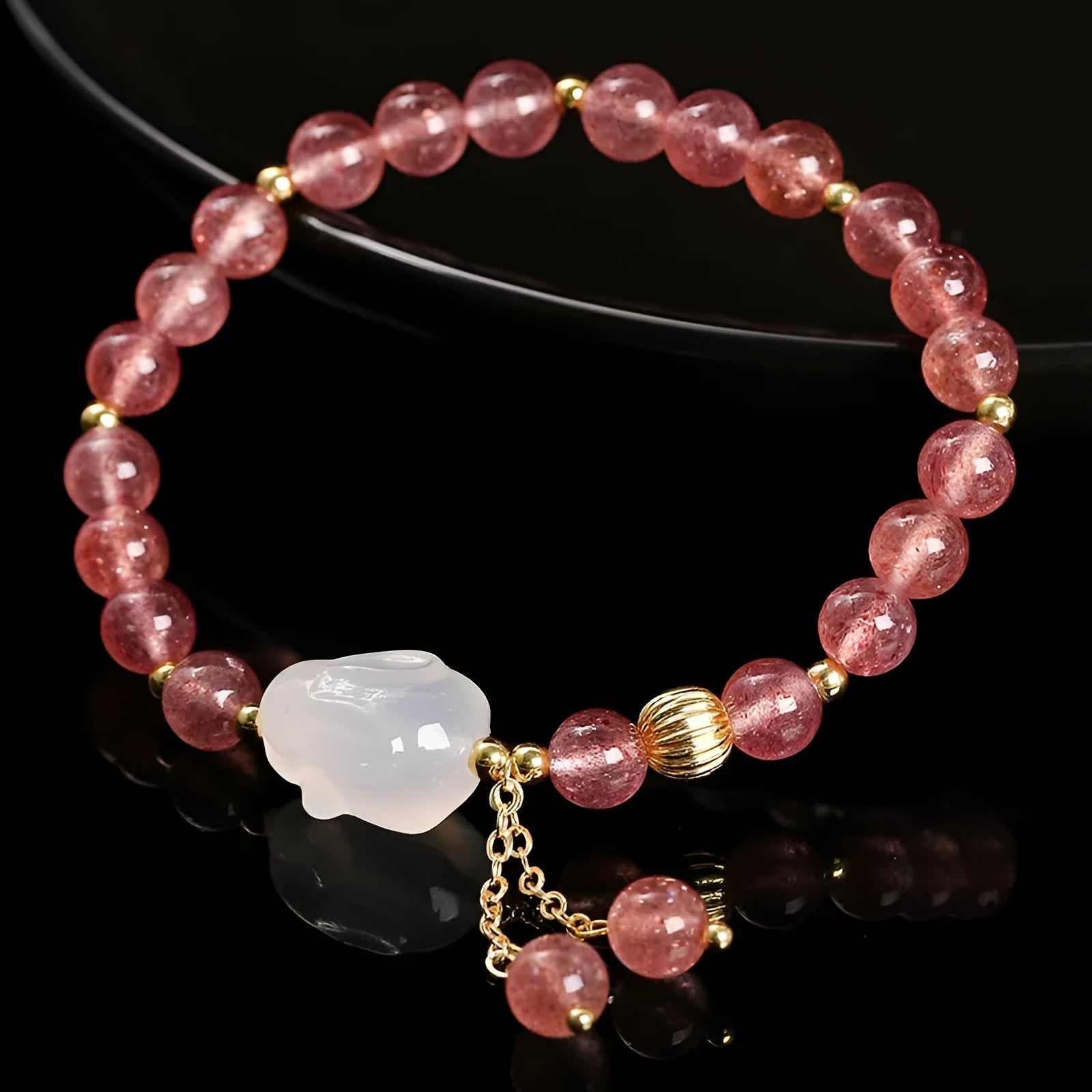 Handcrafted women's bracelet with strawberry quartz and agate beads featuring a white rabbit design.
