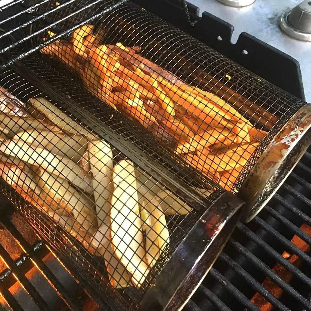 Stainless steel cylindrical rolling grill basket for BBQ with wire mesh, shown with vegetables inside.