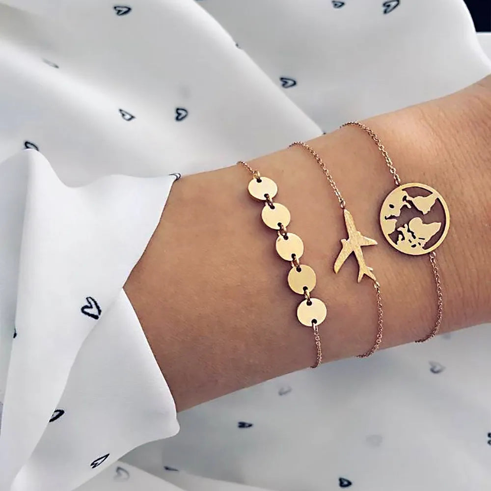 Three bohemian bracelets with heart-shaped alloy charms showing aircraft map designs in sku2104 colour.