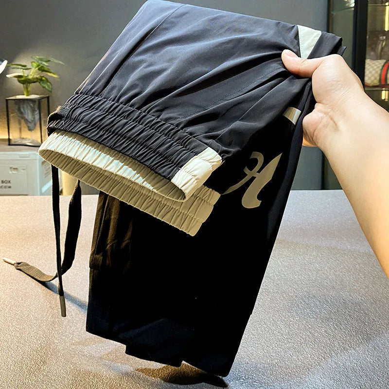 Black men's casual cropped trousers with elasticated ankle bands made from ultra-thin ice silk cotton.