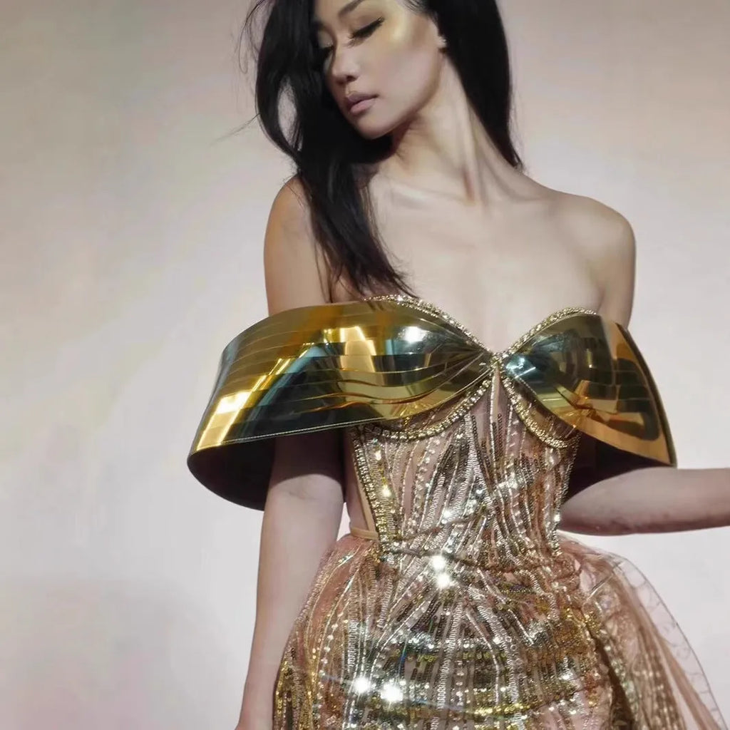 Gold strapless sequin dress with tulle overlay and a long split skirt