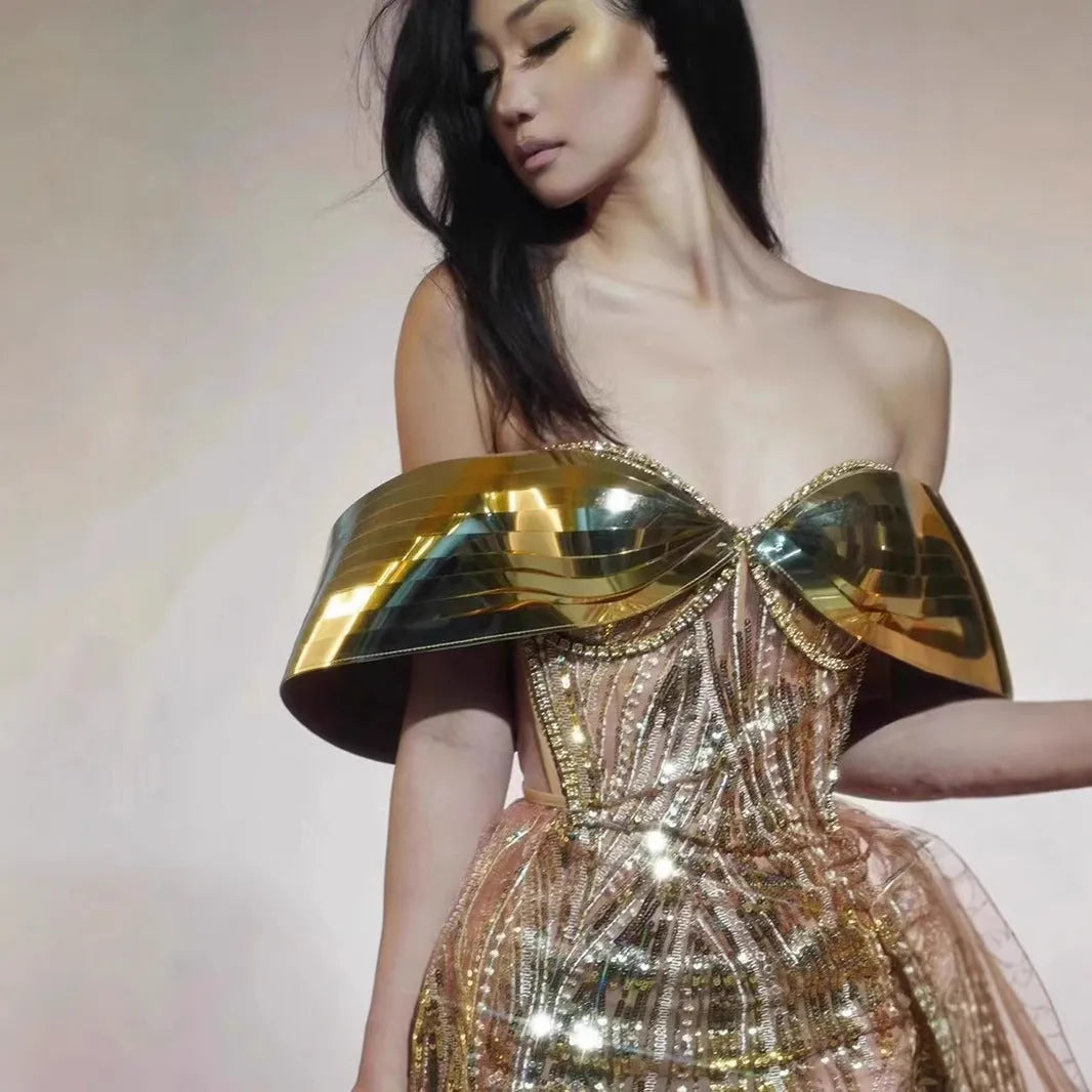 Gold strapless sequin dress with tulle overlay and a long split skirt