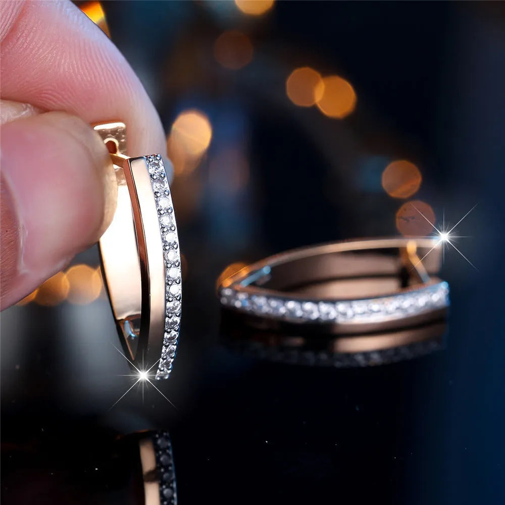 Geometric V-shaped women's ear clips in champagne gold with white diamond accents