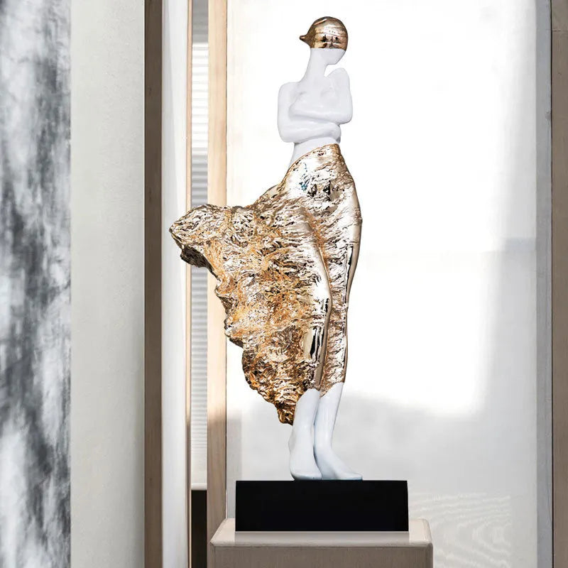 48cm tall sculptured character ornament in natural resin with rose gold finish on wooden surface
