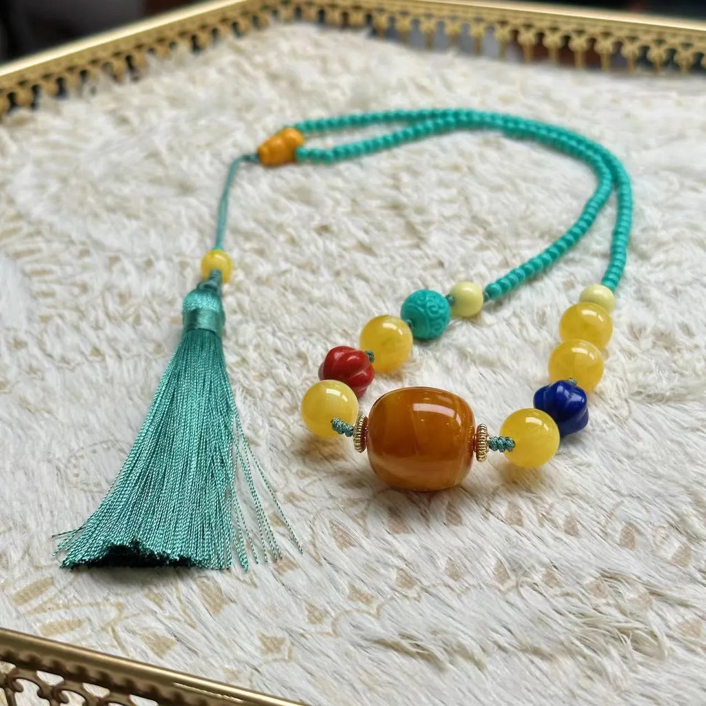 Turquoise mesh flower pendant necklace with adjustable ball bead chain showing hand-woven texture detail