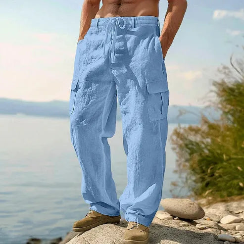 Men's thin cotton wide-leg trousers in light army green with elastic waistband, shown in a casual setting