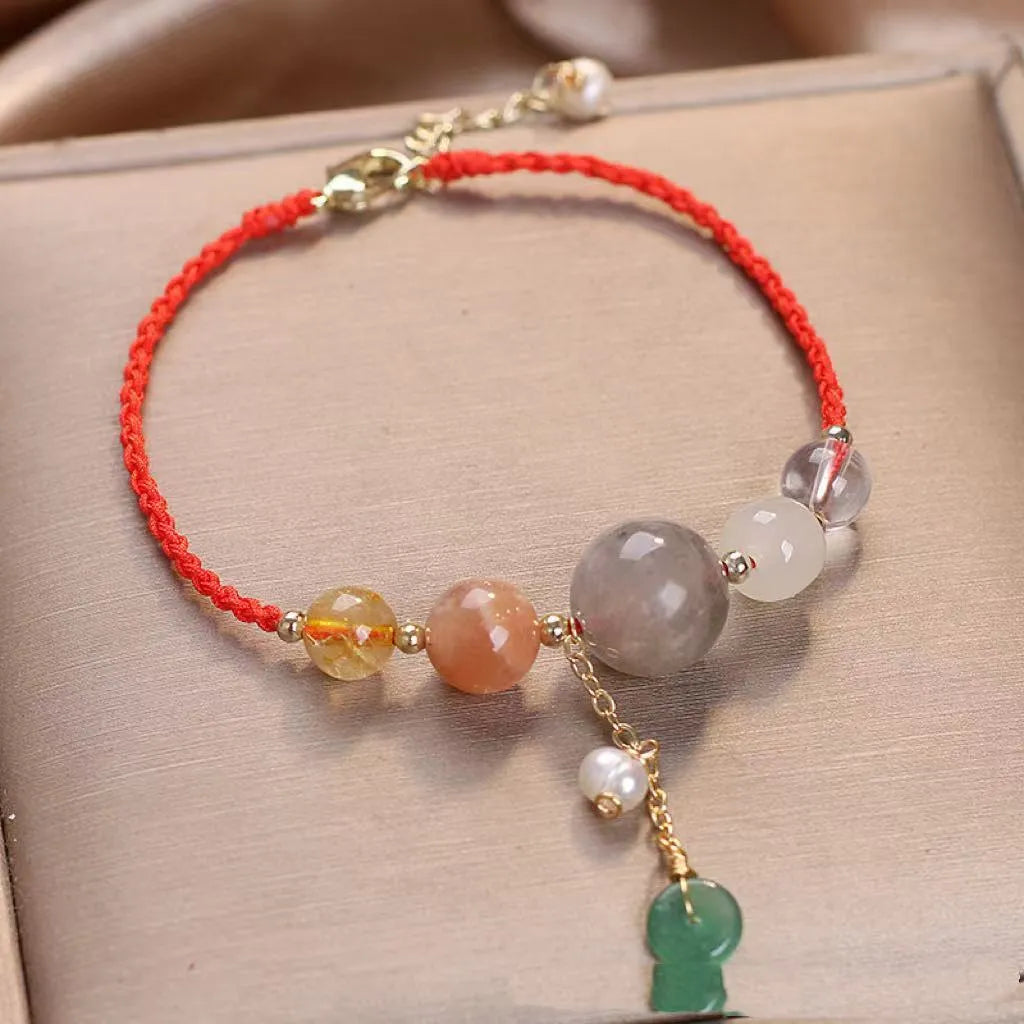 Women's hand-woven crystal and sequin bracelet with a silver peace buckle fastening on a wrist.