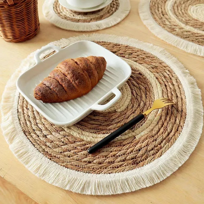 Round Japanese straw placemat with decorative tassels in natural papyrus colour, showing handwoven texture