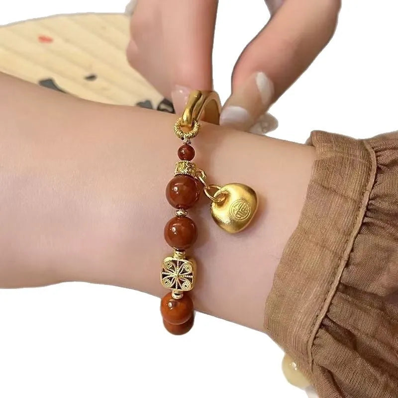 Golden Southern Red Agate character ingot bracelet with antique design on wrist
