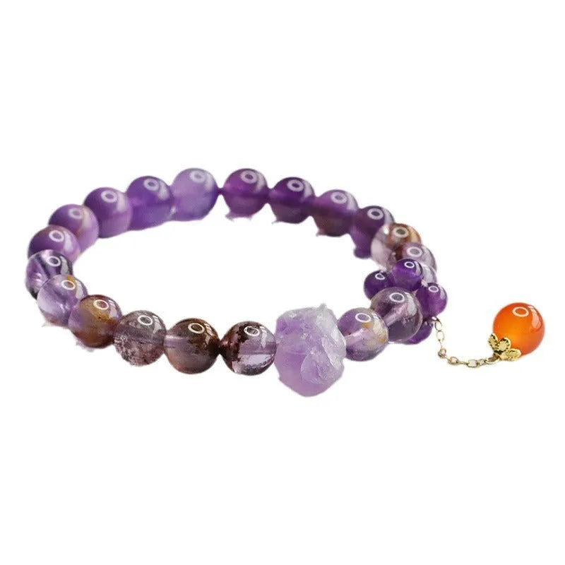 Adjustable nine purple amethyst and red agate Mori-style crystal bracelet showing 8mm beads and organic stone arrangement