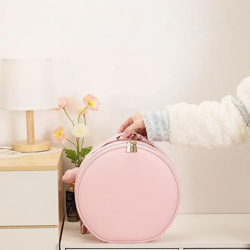 Round pink smart LED makeup bag with mirror lights open, showing internal partitions and adjustable lighting.
