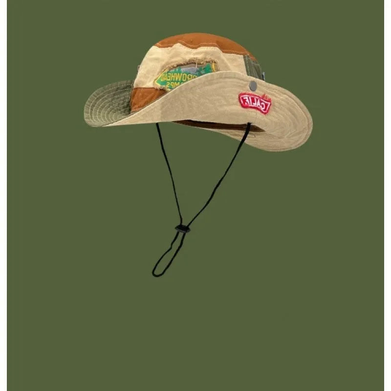 Army green cotton fisherman hat with hand-painted patchwork on flat top crown, folded for storage