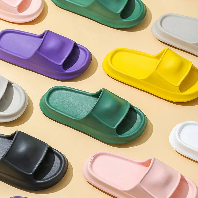 EVA flip-flop slippers with thick sole in multiple colours on a bathroom floor