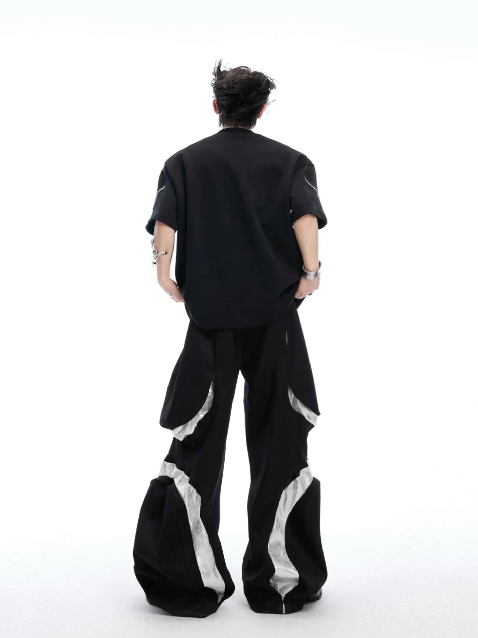 Black men's T-shirt with metal chain detail on padded shoulders, short sleeves, and round neck.