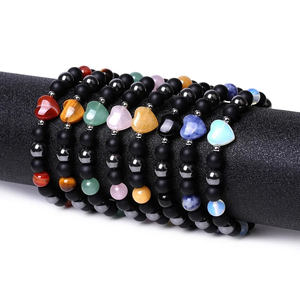 Hand-cut geometric peach heart bracelet in Tigereye stone with cosmic moon and planet elements