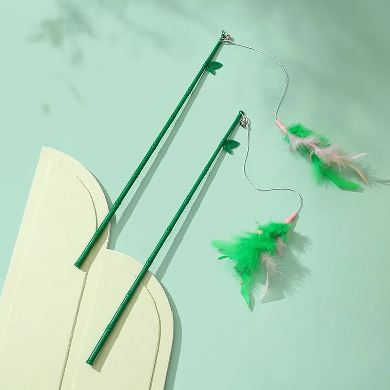 Green interactive cat wand toy with feather and bell attachments for stimulating play