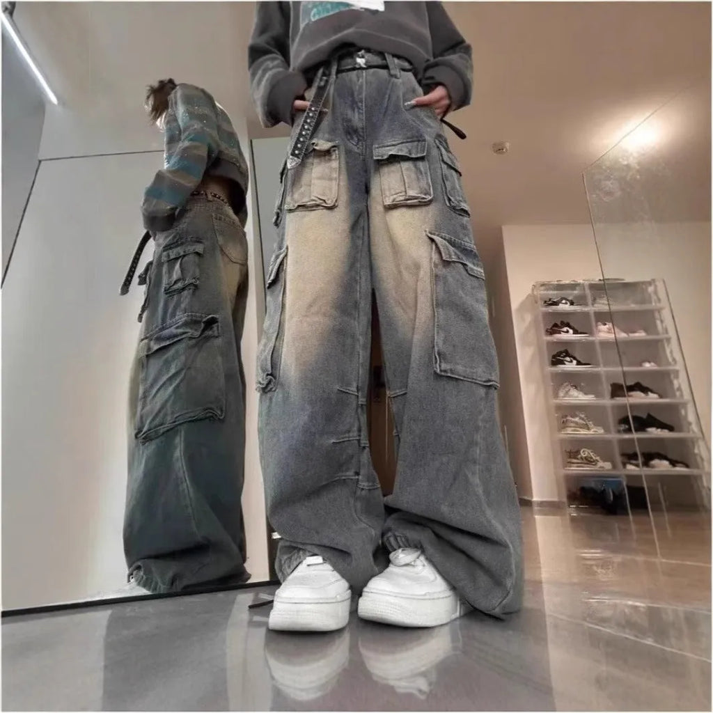 Man wearing light blue loose fit distressed jeans with multiple pockets and straight leg style.