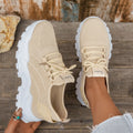 Women's white Flyknit mesh casual sports shoes with flat heel and lace-up front.