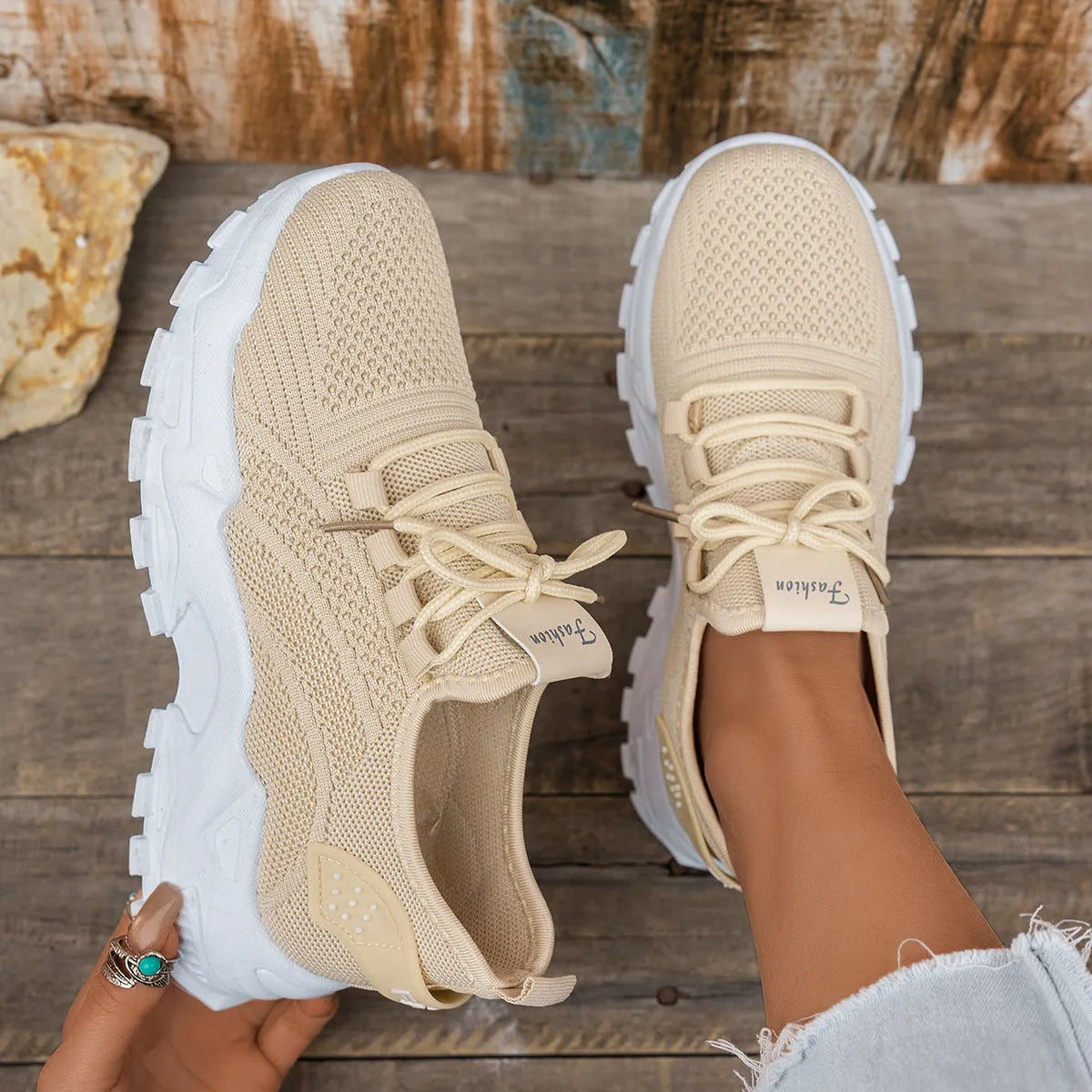 Women's white Flyknit mesh casual sports shoes with flat heel and lace-up front.