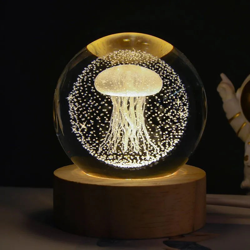 3D crystal ball night light projecting starry sky and planets from its 6cm sphere on a solid wood base.