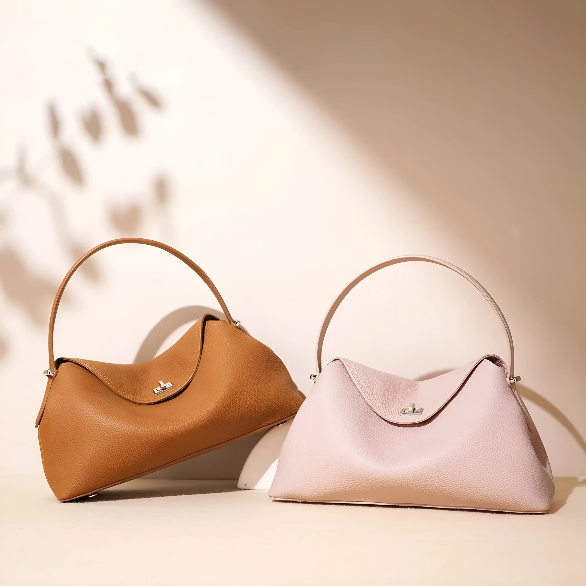 Cowhide leather shoulder messenger bag in a pillow shape with double straps, shown in one of five colour options.