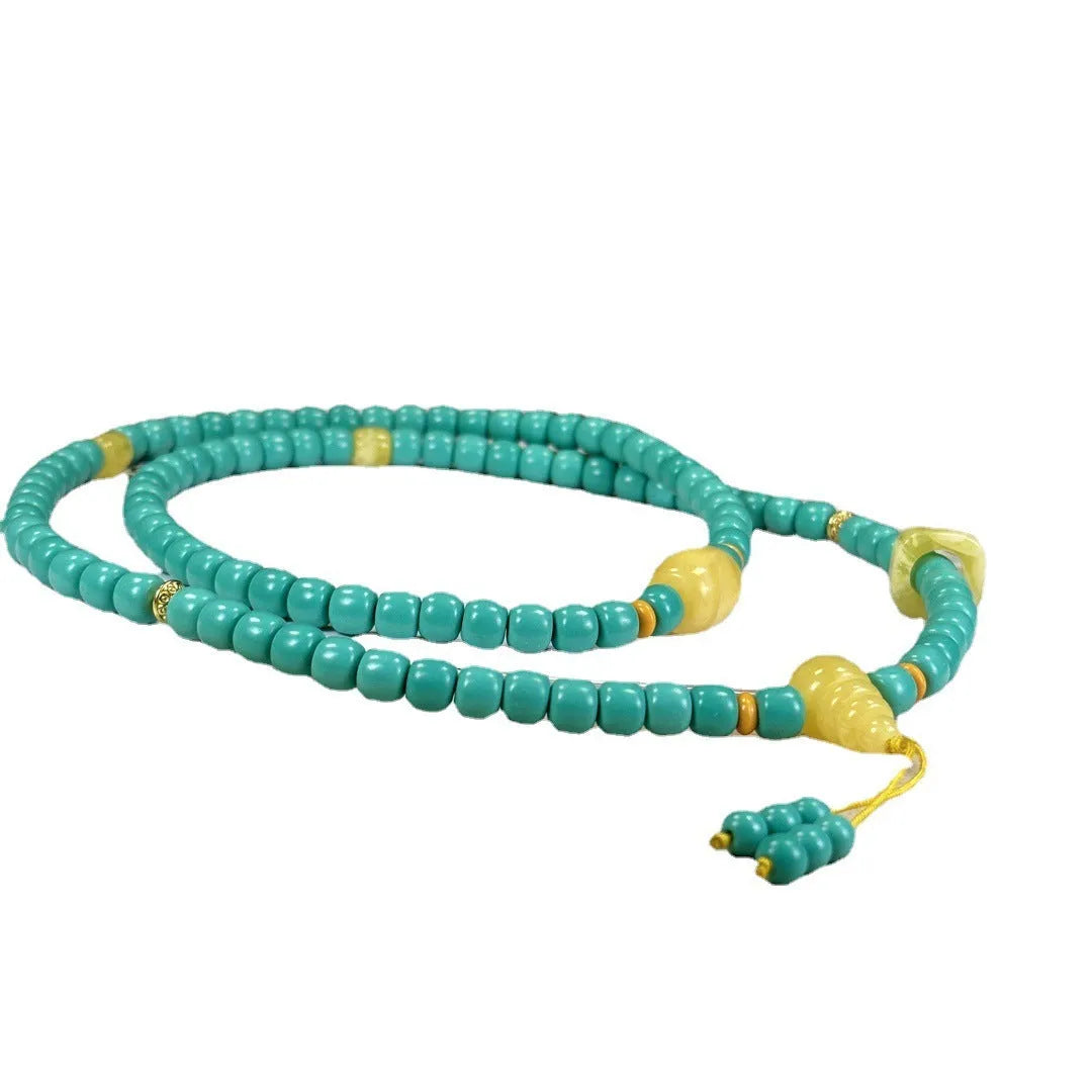 Turquoise mesh flower pendant necklace with adjustable ball bead chain showing hand-woven texture detail