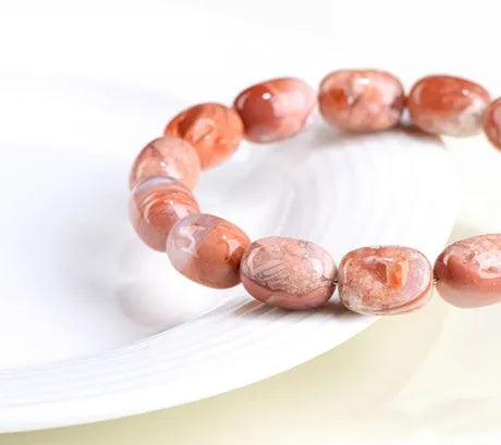 Natural cherry agate barrel shaped bead bracelet showing 10x14mm geometry design with Ruyi elements on wrist