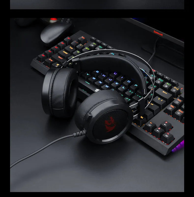 Black wired gaming headset with 2-metre cable and 3.5mm audio connector on a desk