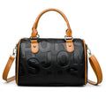 Brown cylindrical PU leather crossbody bag with three shoulder straps showing interior organisation