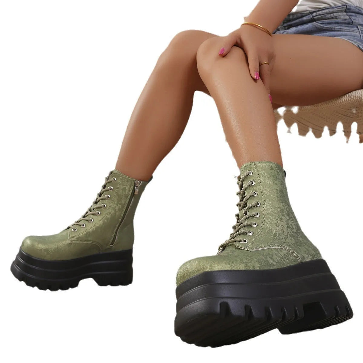 Women's black platform Martin boots with chunky heel and side zipper on a wooden floor