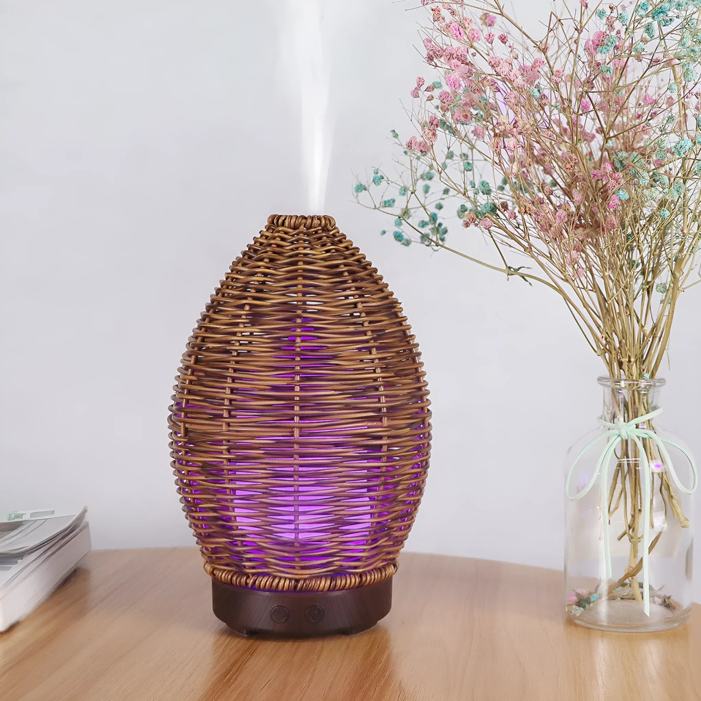Light wood grain hollow rattan aroma diffuser with 100ml water tank on a wooden surface.
