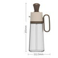 Yellow, green, and brown 550ml glass oil dispenser with silicone brush and stainless steel nozzle.