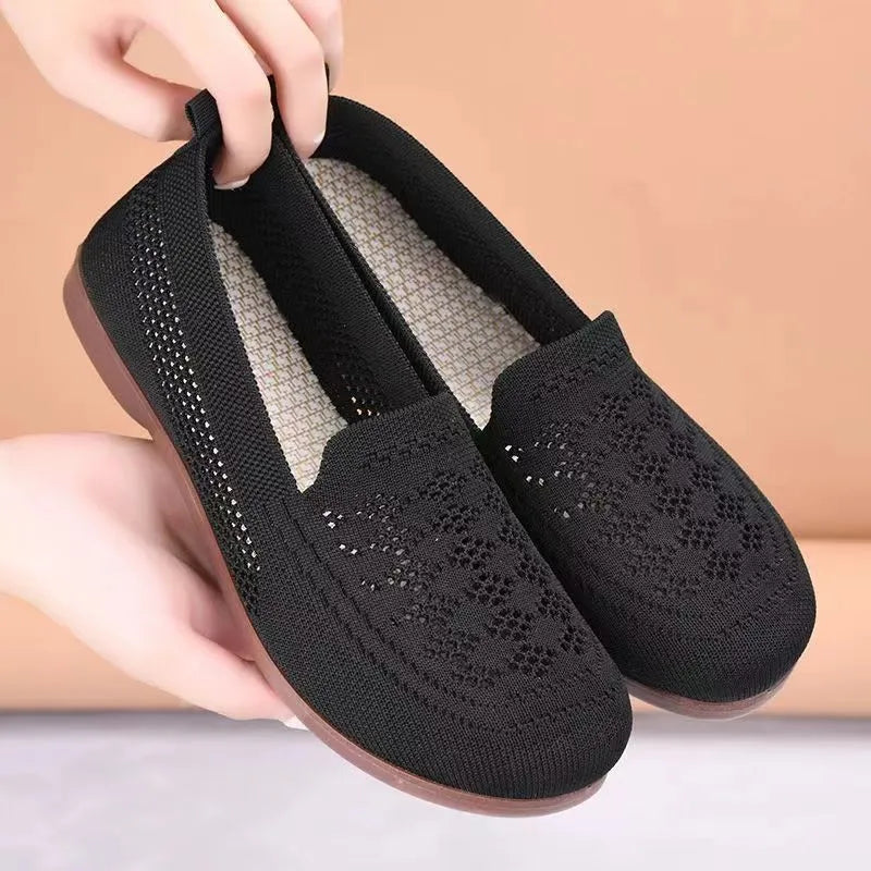 Beige low-top mesh tennis shoes for women with wide feet, showing breathable upper and flat PVC sole.